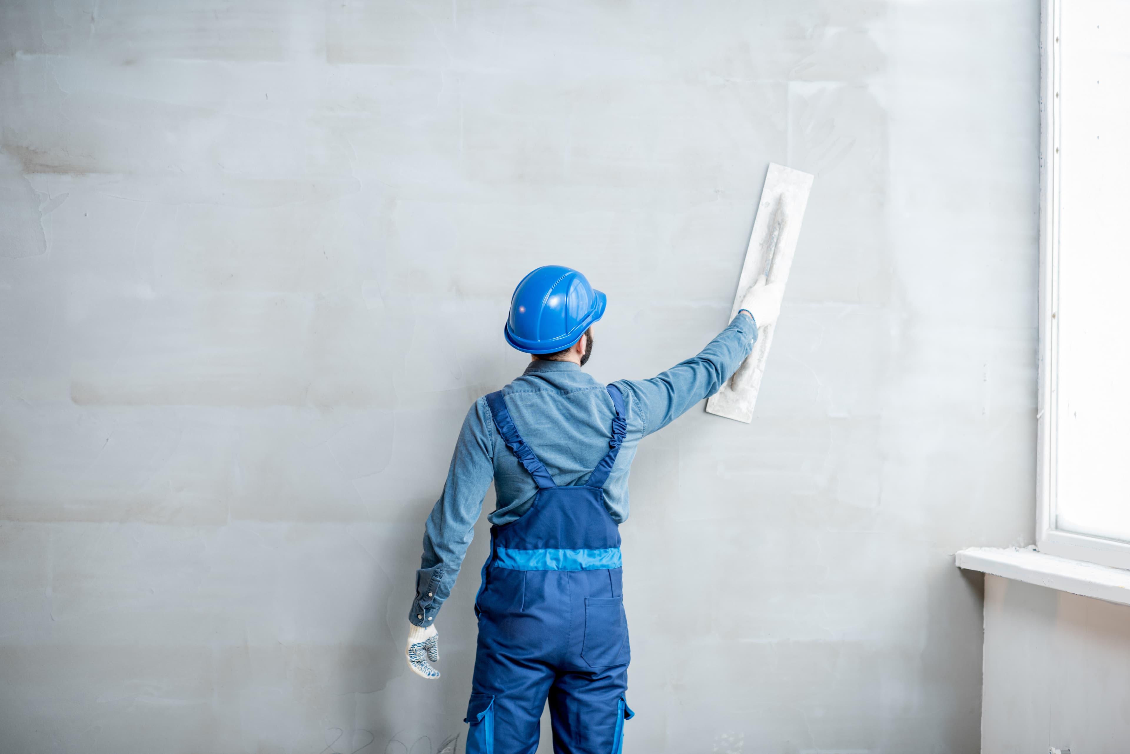 A man plastering - Mobile